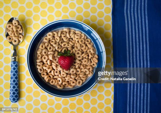 bowl of cereal with strawberry - cheerios stock-fotos und bilder