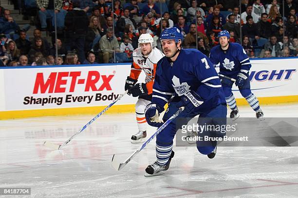 Ian White of the Toronto Maple Leafs skates down the ice during the game against the New York Islanders on December 26, 2008 at the Nassau Coliseum...