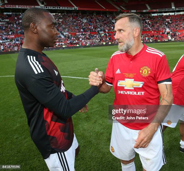 Andrew Cole and Karel Poborsky of Manchester United Legends shake hands after the MU Foundation charity match between Manchester United Legends and...