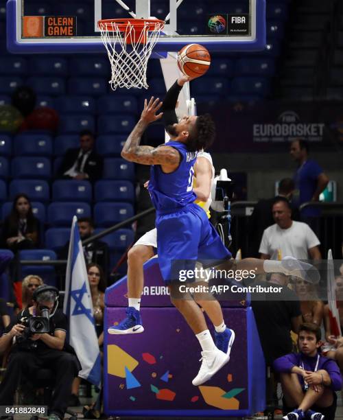 Italy's point guard Daniel Hackett drives to the basket as he is marked by Ukraine's power forward Igor Zaytsev during their FIBA EuroBasket 2017...