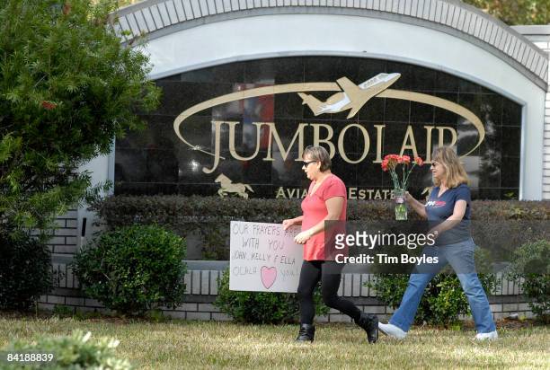 Roberta Armes and Maureen O'Conner , deliver flowers to the front of John Travolta's gated community January 6, 2008 in Ocala, Florida. Travolta's...