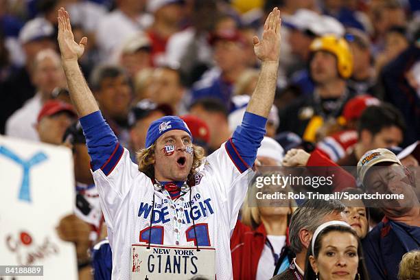Fans of the New York Giants celebrate in the stands during Super Bowl XLII against the New England Patriots on February 3, 2008 at University of...