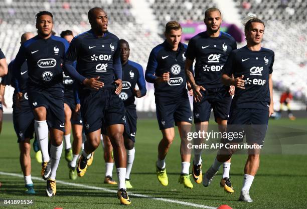 France's midfielder Corentin Tolisso, defender Djibril Sidibe, defender Christophe Jallet, defender Layvin Kurzawa and forward Antoine Griezmann take...