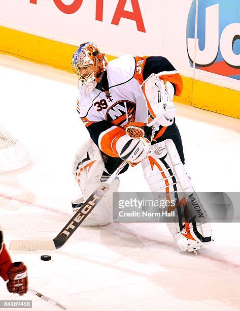 Goaltender Rick DiPietro of the New York Islanders plays the puck against the Phoenix Coyotes on January 2, 2009 at Jobing.com Arena in Glendale,...