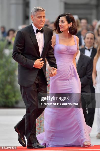 Actor and director George Clooney and his wife Amal attend the premiere of the movie "Suburbicon" presented out of competition at the 74th Venice...