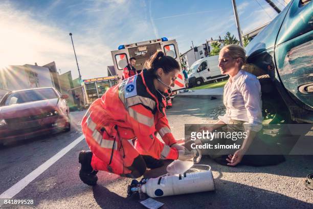paramedics providing first aid - car accident stock pictures, royalty-free photos & images