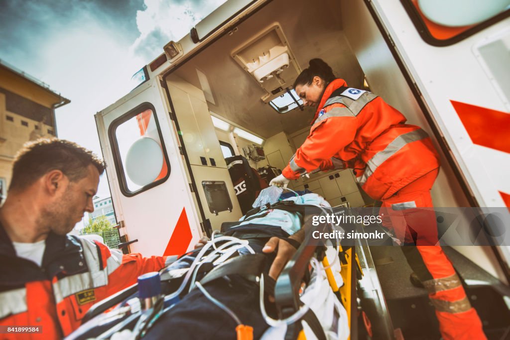 Paramedic team pushing stretcher