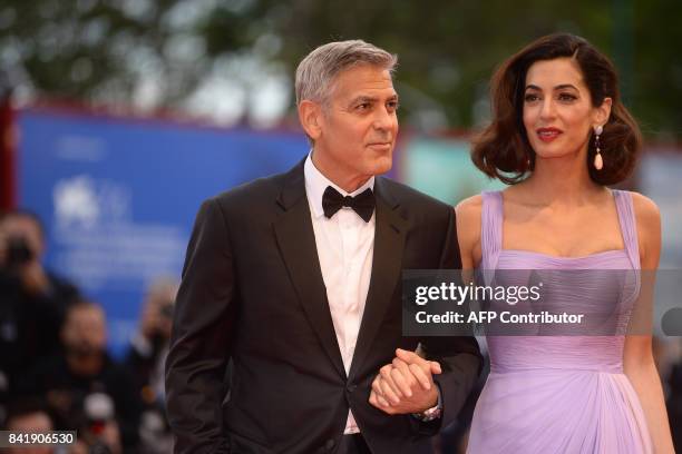 Actor and director George Clooney and his wife Amal attend the premiere of the movie "Suburbicon" presented out of competition at the 74th Venice...