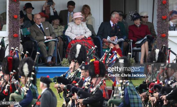 Queen Elizabeth II, Prince Philip, Duke of Edinburgh, Princess Anne, Princess Royal and Prince Charles, Prince of Wales watch the 2017 Braemar...