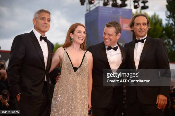 Actor and director George Clooney, US actess Julianne Moore, US actor Matt Damon and French composer Alexandre Desplat attend the premiere of the...