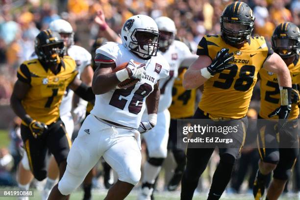 Running back Calan Crowder of the Missouri State Bears runs for a touchdown against Anthony Hines and Eric Beisel of the Missouri Tigers in the first...