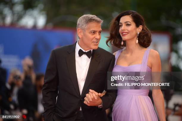 Actor and director George Clooney and his wife Amal attend the premiere of the movie "Suburbicon" presented out of competition at the 74th Venice...