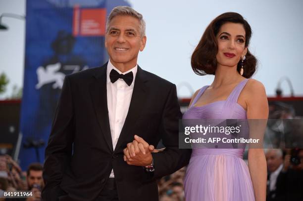 Actor and director George Clooney and his wife Amal attend the premiere of the movie "Suburbicon" presented out of competition at the 74th Venice...