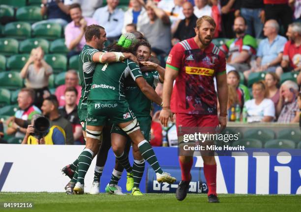 Chris Robshaw of Harlequins reacts as Brendan McKibbin of London Irish celebrates with team mates as he scores their fourth try during the Aviva...