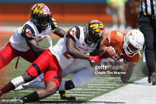 Qwuantrezz Knight of the Maryland Terrapins tackles Devin Duvernay of the Texas Longhorns in the second qurter at Darrell K Royal-Texas Memorial...