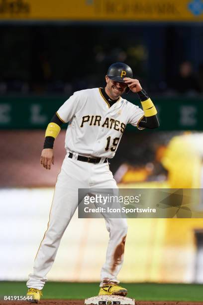 Pittsburgh Pirates catcher Chris Stewart smiles after being called safe on second base in the second inning during a MLB game between the Pittsburgh...