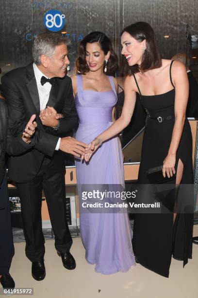 George Clooney, Amal Clooney and Rebecca Hall attend the 'Hollywood Foreign Press Association Cocktail Party' during the 74th Venice Film Festival on...