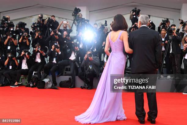 Actor and director George Clooney and his wife Amal attend the premiere of the movie "Suburbicon" presented out of competition at the 74th Venice...