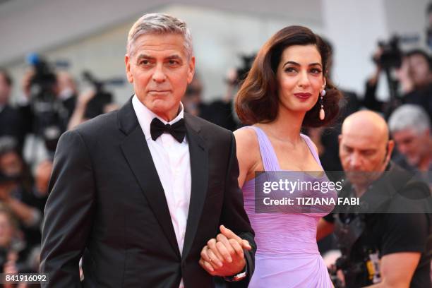 Actor and director George Clooney and his wife Amal attend the premiere of the movie "Suburbicon" presented out of competition at the 74th Venice...