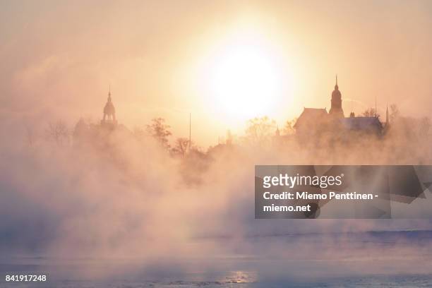 A freezing winter morning in Helsinki: sun coming up behind the mist rising from the frozen sea