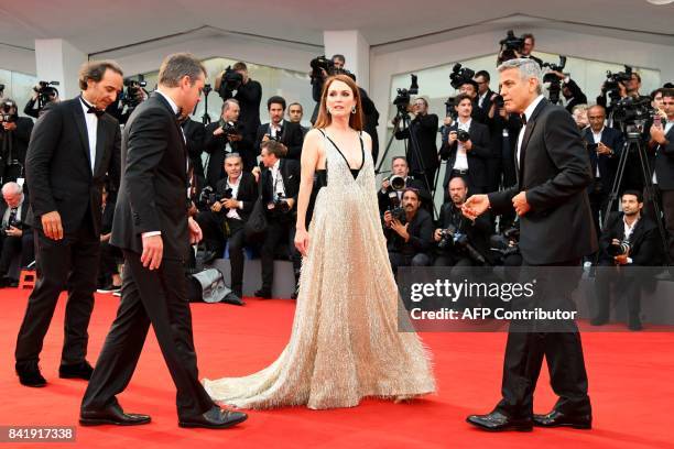 French composer Alexandre Desplat, US actor Matt Damon, US actess Julianne Moore and US actor and director George Clooney attend the premiere of the...