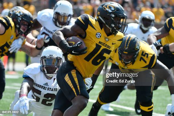 Running back Damarea Crockett of the Missouri Tigers rushes against McNeece Egbim of the Missouri State Bears in the second quarter at Memorial...