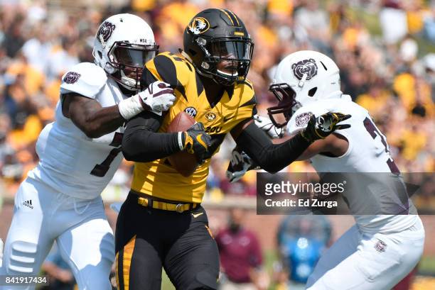 Wide receiver Nate Brown of the Missouri Tigers catches a pass against Tre Betts of the Missouri State Bears in the second quarter at Memorial...