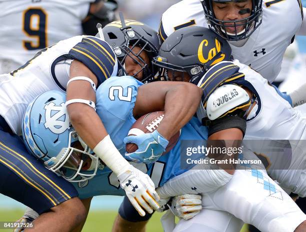 Derron Brown and Marloshawn Franklin Jr. #18 of the California Golden Bears tackle Jordon Brown of the North Carolina Tar Heels during their game at...