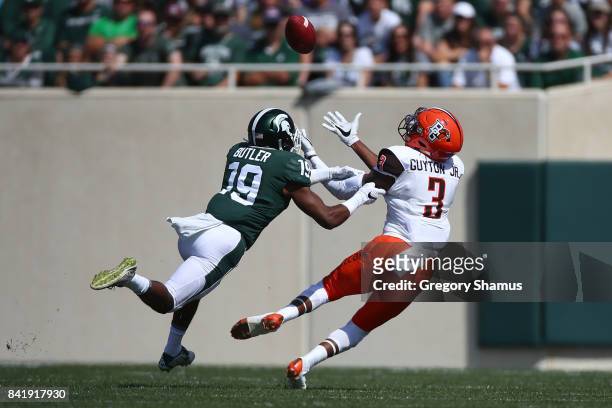 Datrin Guyton of the Bowling Green Falcons catches a first half pass next to Josh Butler of the Michigan State Spartans at Spartan Stadium on...