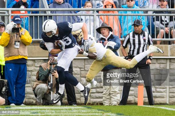 Mike Gesicki of the Penn State Nittany Lions hangs on to a touchdown reception as James King of the Akron Zips attempts to tackle at 0:49 in the...