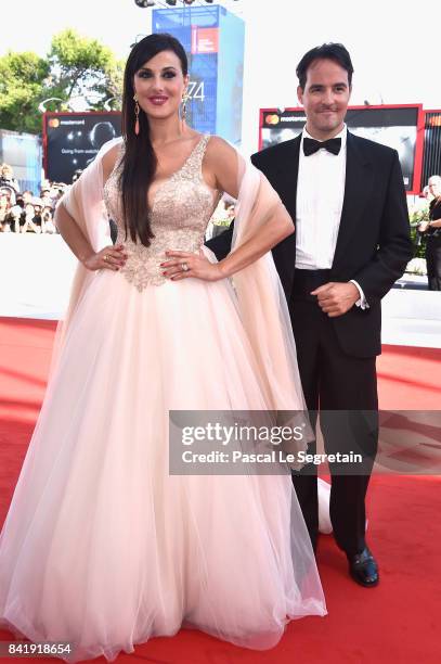 Vittorio Palazzi and Isabelle Adriani walk the red carpet ahead of the 'Foxtrot' screening during the 74th Venice Film Festival at Sala Grande on...