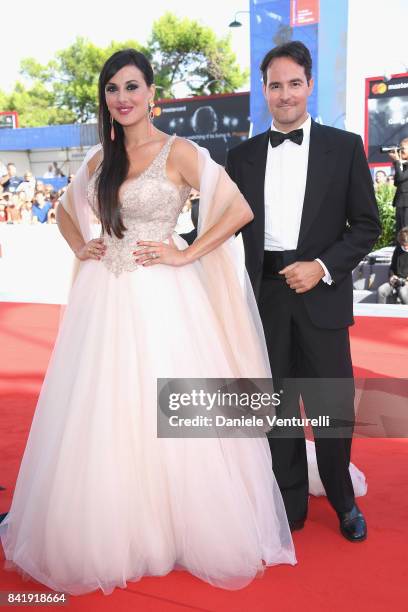 Vittorio Palazzi and Isabelle Adriani walk the red carpet ahead of the 'Foxtrot' screening during the 74th Venice Film Festival at Sala Grande on...