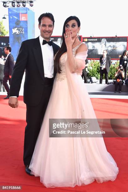 Vittorio Palazzi and Isabelle Adriani walk the red carpet ahead of the 'Foxtrot' screening during the 74th Venice Film Festival at Sala Grande on...