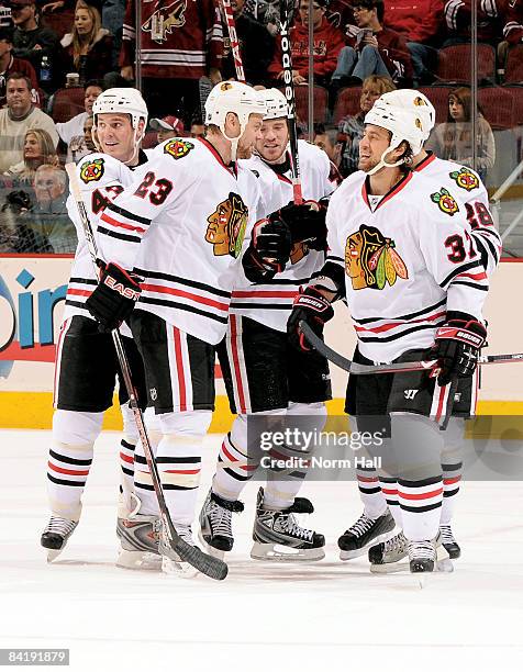 James Wisniewski, Aaron Johnson, Adam Burish and Craig Adams of the Chicago Blackhawks celebrate a goal against the Phoenix Coyotes on January 6,...