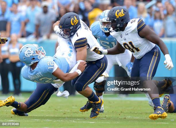 Devante Downs of the California Golden Bears tackles Chazz Surratt of the North Carolina Tar Heels during their game at Kenan Stadium on September 2,...