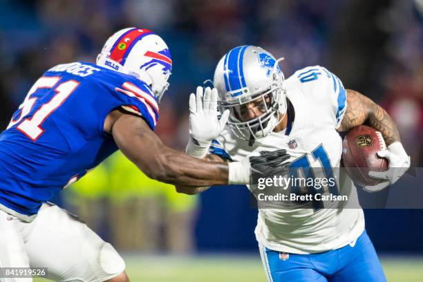 Matt Asiata of the Detroit Lions is brought down by Gerald Hodges of the Buffalo Bills during the preseason game on August 31, 2017 at New Era Field...