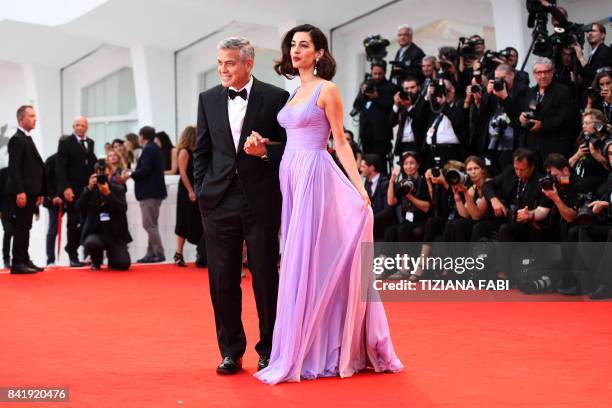 Actor and director George Clooney and his wife Amal attend the premiere of the movie "Suburbicon" presented out of competition at the 74th Venice...