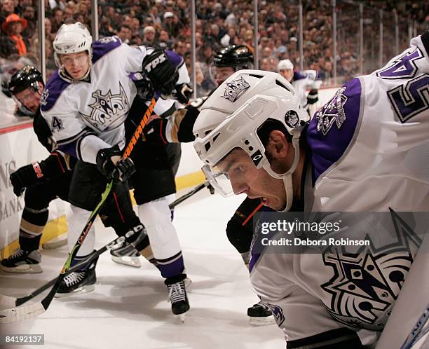 Teddy Purcell and Alexander Frolov of the Los Angeles Kings battle alongside the boards against the Anaheim Ducks during the game on January 6, 2009...