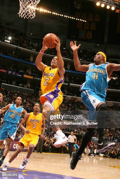Derek Fisher of the Los Angeles Lakers goes up for a shot against James Posey of the New Orleans Hornets at Staples Center on January 6, 2009 in Los...