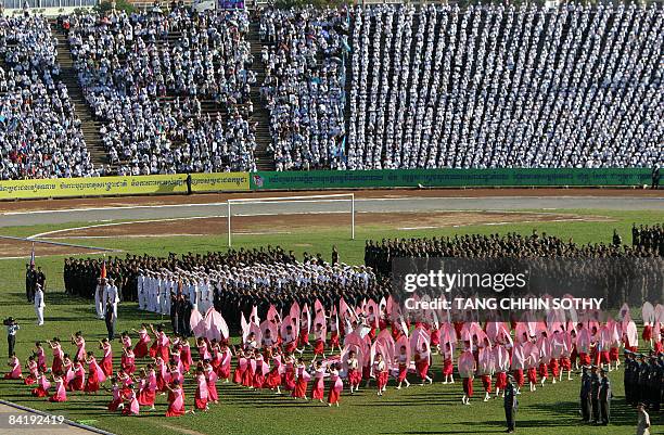 Performers dance during a ceremony marking the 30th anniversary of the fall of the Khmer Rouge regime at the National Stadium in Phnom Penh on...