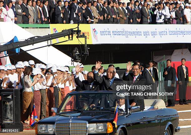 Cambodia's senate president Chea Sim , Prime Minister Hun Sen , and president of the National Assembly Heng Samrin wave to supporters during the...