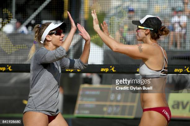 April Ross and Lauren Fendrick celebrate after winning a point during their match against Angela Bensend and Geena Urango at the AVP Championships in...