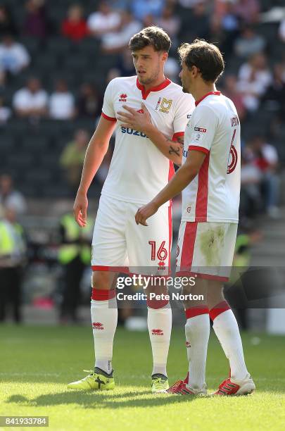 Robbie Muirhead of Milton Keynes Dons talks to team mate Ed Upson during the Sky Bet League One match between Milton Keynes Dons and Oxford United at...