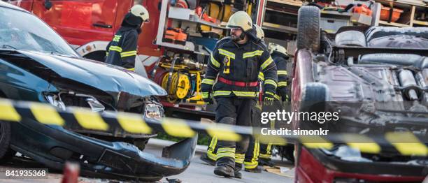 firefighters at accident"n - fireman uniform stock pictures, royalty-free photos & images