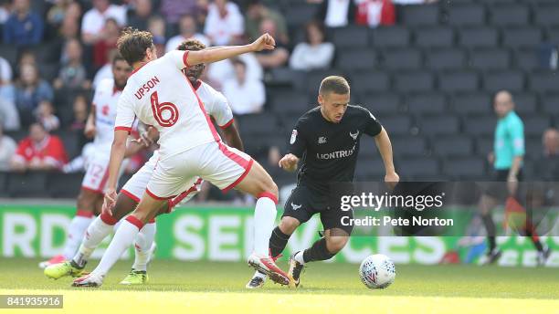 Jack Payne of Oxford United moves past Ed Upson of Milton Keynes Dons during the Sky Bet League One match between Milton Keynes Dons and Oxford...