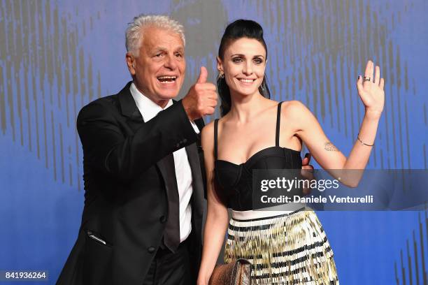 Michele Placido and Federica Vincenti walk the red carpet ahead of the 'Suburra. La Serie' screening during the 74th Venice Film Festival at Sala...