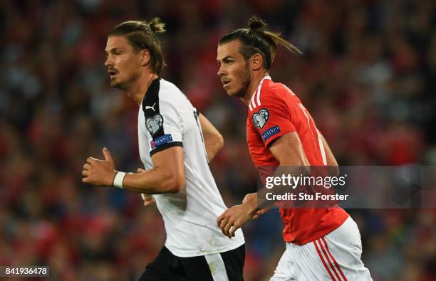 Gareth Bale of Wales and Sebastian Proedl of Austria in action during the FIFA 2018 World Cup Qualifier between Wales and Austria at Cardiff City...