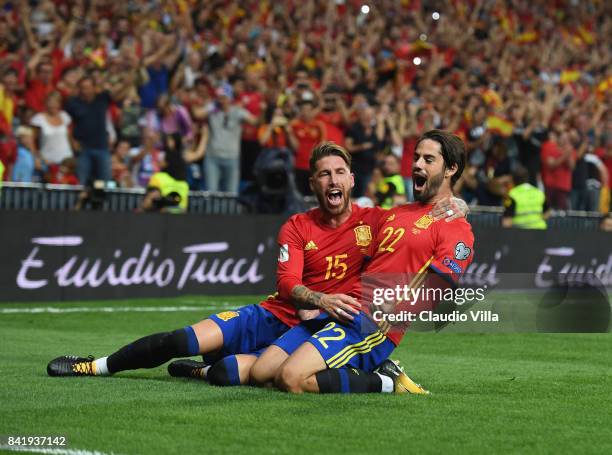 Spain's midfielder Isco celebrates with Sergio Ramos after scoring the opening goal during the FIFA 2018 World Cup Qualifier between Spain and Italy...