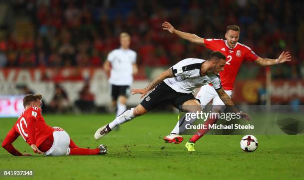 Marko Arnautovic of Austria takes on Chris Gunter and Aaron Ramsey of Wales during the FIFA 2018 World Cup Qualifier between Wales and Austria at...