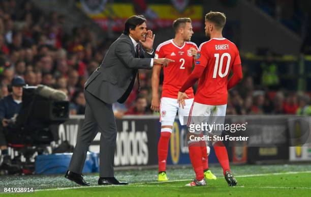 Chris Coleman manager of Wales gives instructions to Aaron Ramsey of Wales during the FIFA 2018 World Cup Qualifier between Wales and Austria at...
